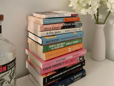 Stack of colorful books with flowers