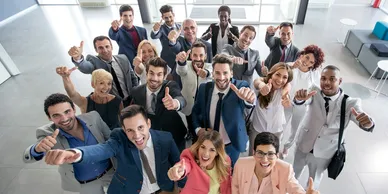 Group of professionals cheering in office