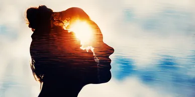 Speaker silhouette at sunrise with light flares